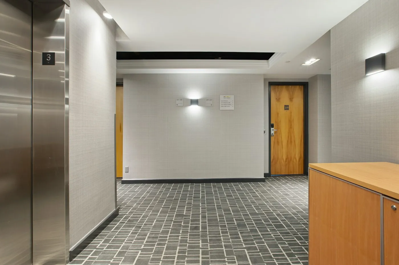 Illustrative commercial corridor with an elevator and shared floor area